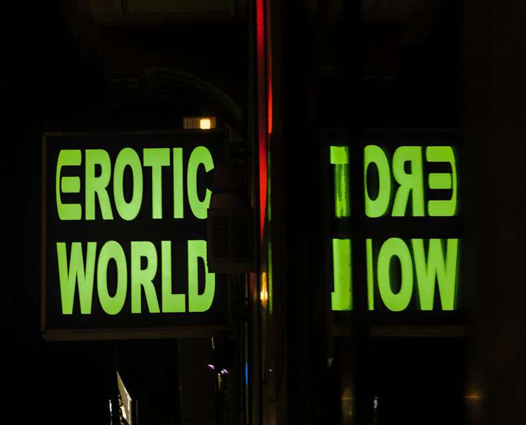 An erotic world neon sign at night