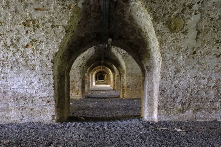 A look down a series of doorways through tick foundations of an old fort