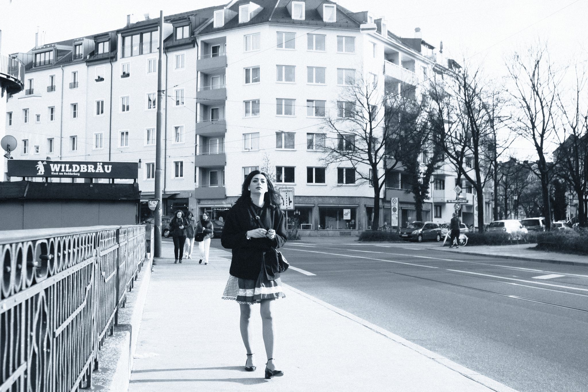 A woman walking across a bridge
